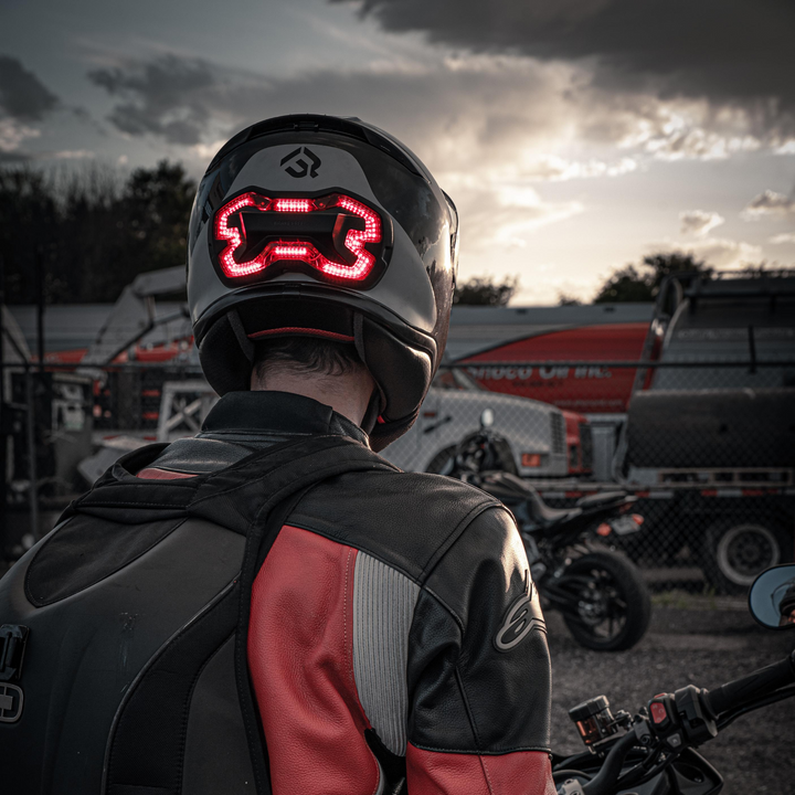 Lifestyle photo of Brake Free. Brake Free is an ultra-bright smart LED brake light that instantly improves rider's visibility. Simple installation, no wires. Smart brake light for your helmet. Be seen day and night. Ride in any weather. Long lasting rechargeable lithium ion battery.