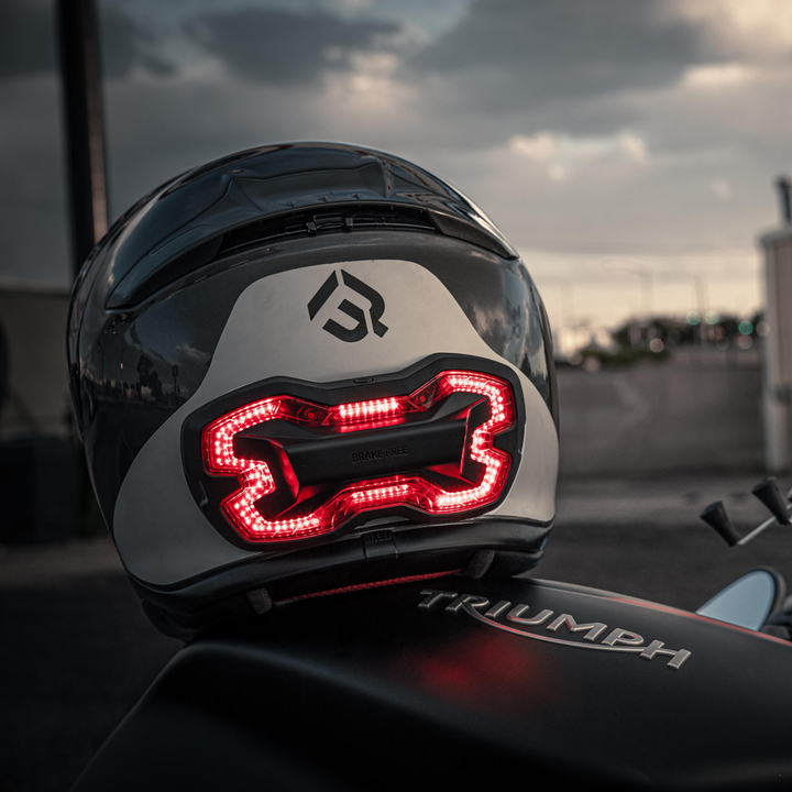Lifestyle photo of Brake Free. Ride with confidence and style with Brake Free. Brake Free - an ultra-bright smart LED brake light that instantly improves rider's visibility. Simple installation, no wires. Smart brake light for your helmet. Be seen day and night. Ride in any weather. Long lasting rechargeable lithium ion battery.